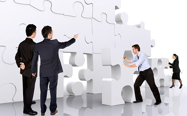 business teamwork - business men making a puzzle over a white background